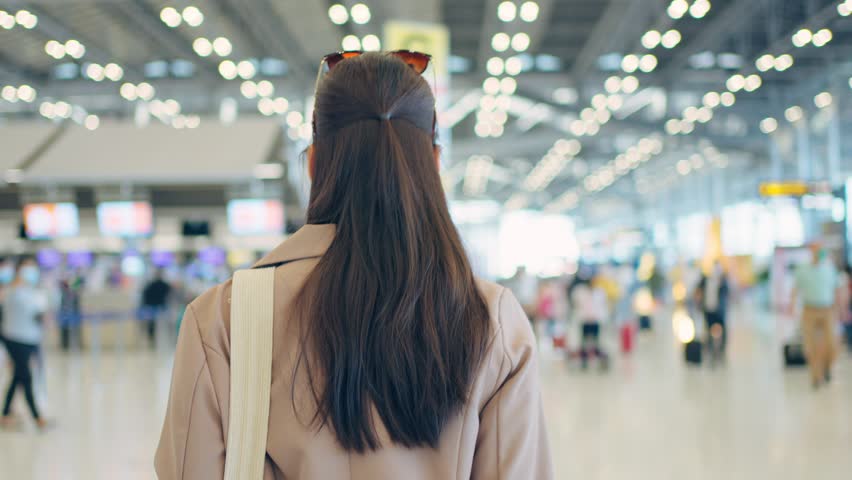 Portrait of Asian young girl walk in airport terminal to boarding gate. Attractive beautiful female tourist passenger feel happy and excited to go travel abroad by airplane for holiday vacation trip. Royalty-Free Stock Footage #1099637227