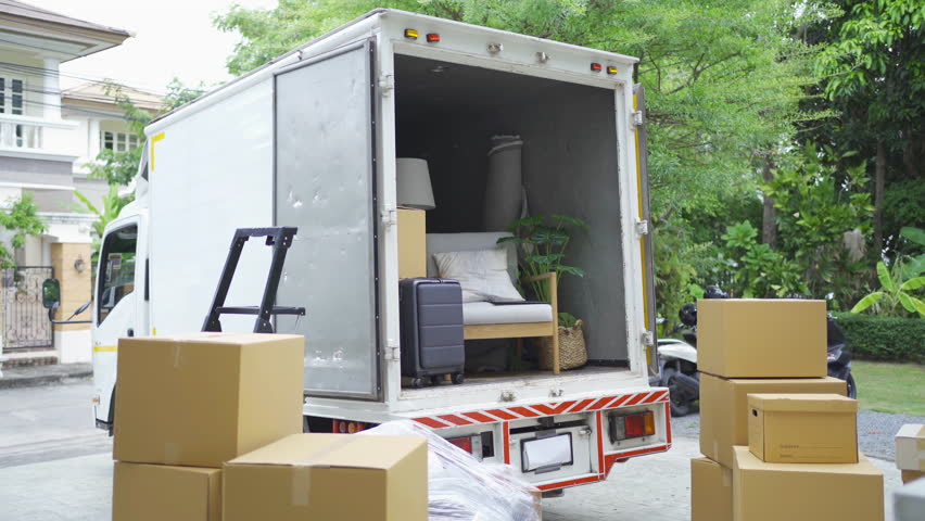 Truck car moving house for customers, delivering boxes and furniture. Vehicle transportation. Shipping and packaging business occupation service company. People lifestyle. Royalty-Free Stock Footage #1099643545