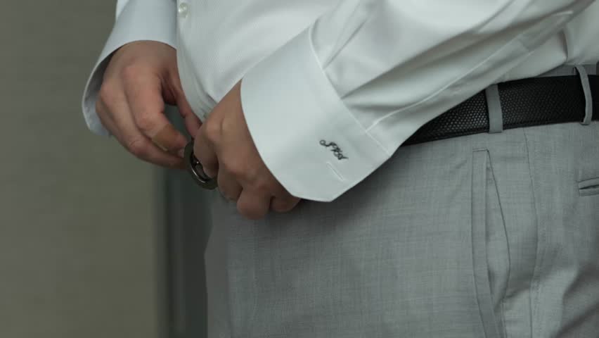 A Man Puts A Belt On His Pants With A White Shirt | Shutterstock HD Video #1099646523