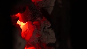 Video detail of red-hot charcoal with fire inside a wood-fired oven. Concept of industry, food preparation with fire. Grills.