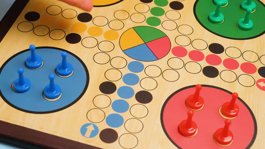 People play Ludo or Pachisi board game on beautiful wooden play board. Ludo is a strategy board game for two to four players. 4K resolution family board game video. Royalty-Free Stock Footage #1099648749