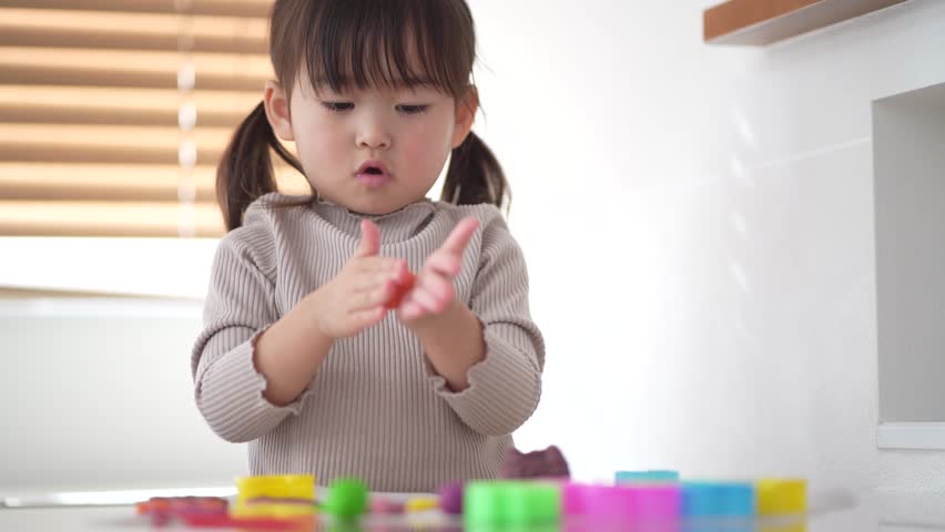 Image of a girl playing with clay
