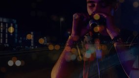 Animation of blurred night road traffic over caucasian man playing harmonica on concert. Music, entertainment and night city life concept digitally generated video. - Powered by Shutterstock - Get 15% off with code: PIKWIZARD15