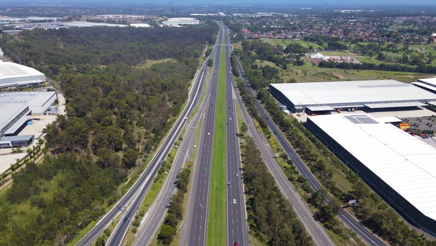 Aerial drone pullback reverse view of the Light Horse Interchange in Sydney, NSW Australia at the junction of the M4 Western Motorway and the Westlink M7 Royalty-Free Stock Footage #1099653273