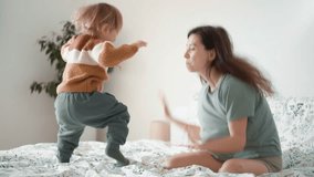 close up of young happy smiling asian mother play laugh with her curly toddler son baby in morning bedroom. Concept of children, baby, parenthood, childhood, life, maternity, motherhood relationship - Powered by Shutterstock - Get 15% off with code: PIKWIZARD15
