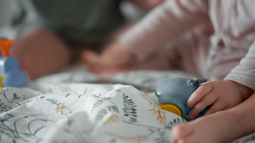close up shot details of mother play toy cars with her toddler son baby in morning bedroom. Concept of children, baby, parenthood, childhood, life, maternity, motherhood relationship. Faceless frame Royalty-Free Stock Footage #1099653889