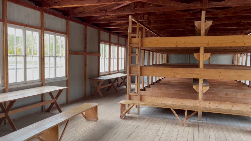 Barracks interior with wooden bunk beds at Dachau Concentration camp in Germany. Holocaust museum concept