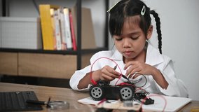 Asian littlle girl constructing and coding robot at STEM class,Fixing and repair mechanic toy car - Powered by Shutterstock - Get 15% off with code: PIKWIZARD15