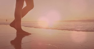 Animation of lights over legs of caucasian woman walking on beach. Active lifestyle, sport, relax and sea concept digitally generated video.