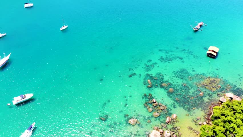 Big Island, Pouso Beach -  Angra dos Reis, State of Rio de Janeiro - Paradise Island. Sea with clear water on a sunny day. Drone Top View, Brazil, Carnival. | Shutterstock HD Video #1099663615