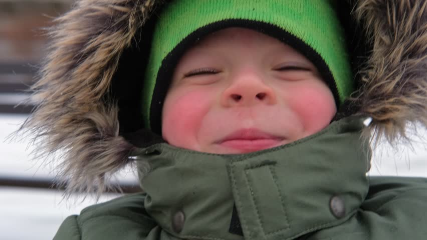Happy Kid Having Fun on Carousel. Front View of Smiling Little Boy Enjoying an Merry-go-round Attraction. Amusement Kiddie Ride. POV. Carefree Young Child Spinning at Playground Carrousel Closeup Face