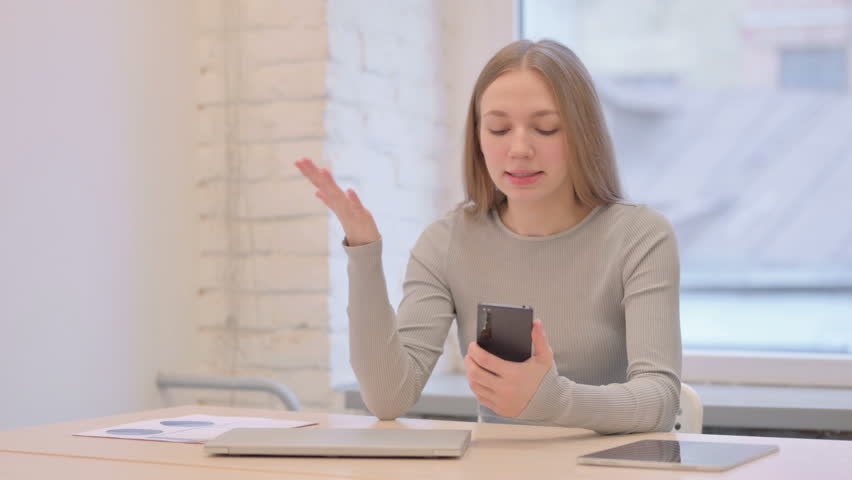 Upset Creative Young Woman Reacting to Loss on Smartphone | Shutterstock HD Video #1099664833