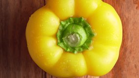 Yellow, red and green wet bell pepper rotated on wooden background, top view. Mixed fresh colorful Bell Peppers - Powered by Shutterstock - Get 15% off with code: PIKWIZARD15