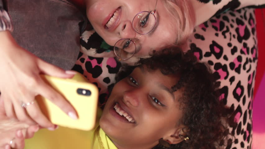 Female friends looking at a smartphone together