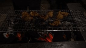 closeup 4k video of chicken being grilled on charcoal fire. 
