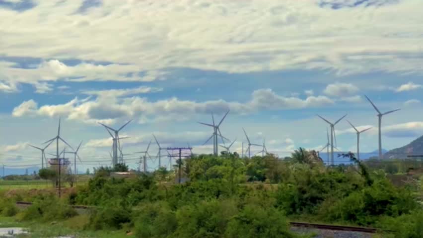 Windmills for electric power production in Vietnam. Wind turbines farm, windmill farm producing green energy on natural background. Renewable Energy concept, technology landscape  | Shutterstock HD Video #1099677627