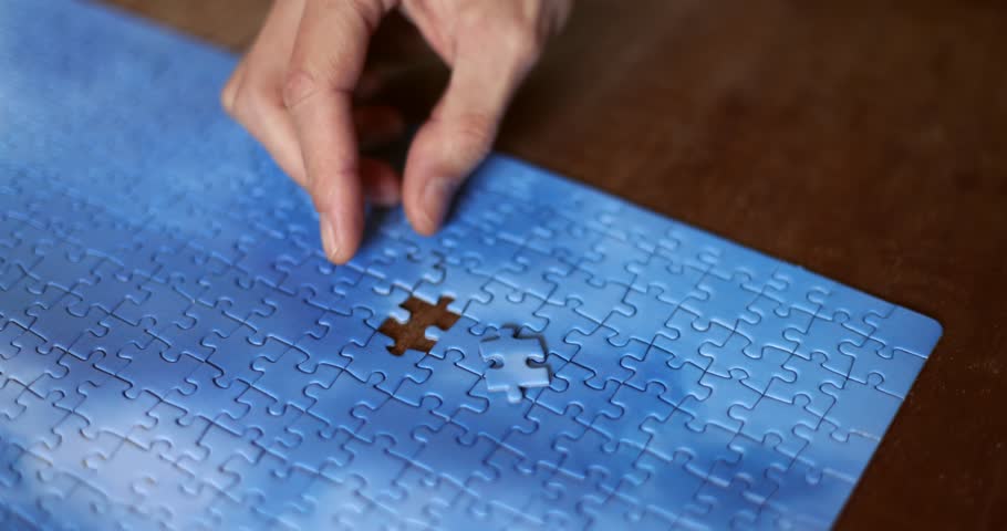 The missing piece of the sky puzzle, the concept of completing a big job, the final of the project, the successful solution of business problems. The hand puts the last piece of the jigsaw