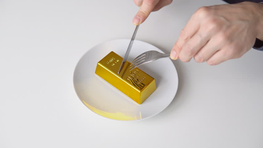 Businessman sitting with fork and knife ready to eat bar of gold served on plate | Shutterstock HD Video #1099681211