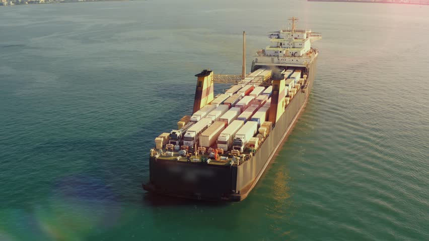 Freight cargo ship with trucks and containers in sea, aerial view from drone. Commercial trade logistic and international transportation concept | Shutterstock HD Video #1099681757