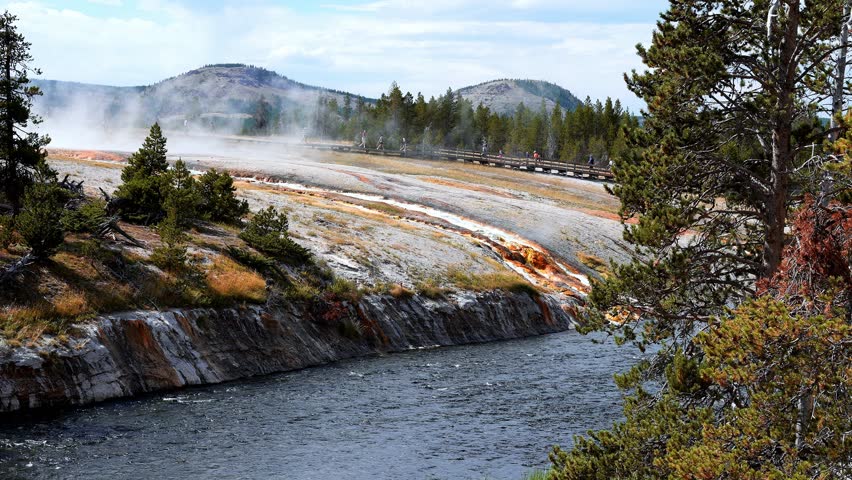 Beautiful view of hot spring pool geothermal landscape. Geyser basin and forest. Famous tourist attraction at Yellowstone national park. Hot thermal spring Black Pool in Yellowstone National Park