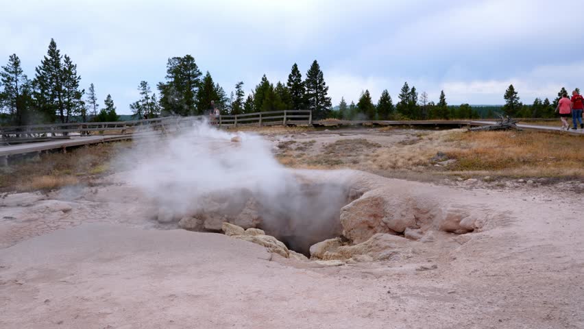 Beautiful view of hot spring pool geothermal landscape. Geyser basin and forest. Famous tourist attraction at Yellowstone national park. Hot thermal spring Black Pool in Yellowstone National Park