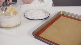 Time lapse. Scooping cookie dough into the baking sheet to bake coconut cookies.