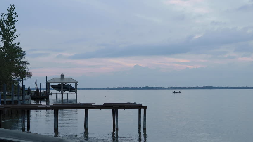 young man taking photos on a boat dock 