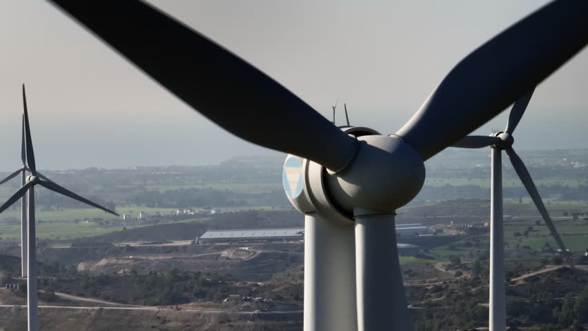 Aerial view close-up of a spinning wind turbine. Production of ecological energy at a wind power station. High quality 4k footage | Shutterstock HD Video #1099683287