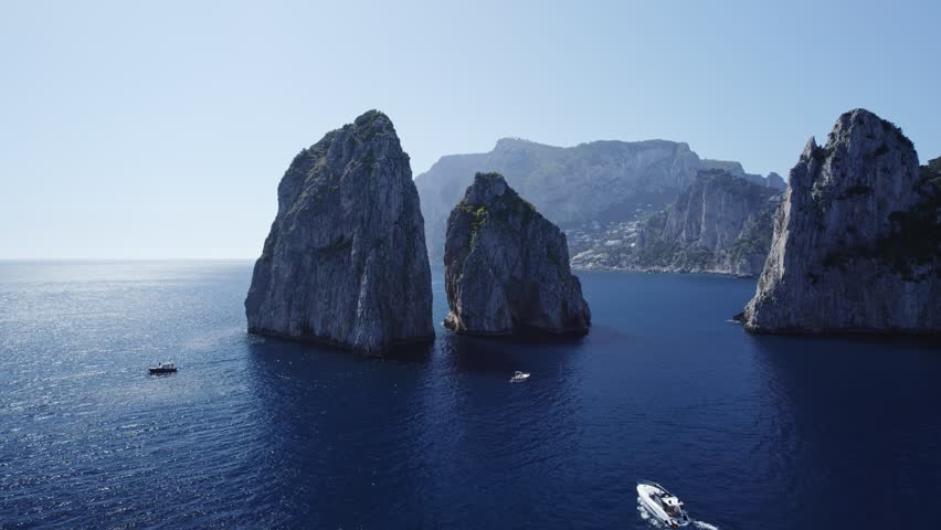 capri island Faraglioni Rocks and alone boat drone view Royalty-Free Stock Footage #1099685123