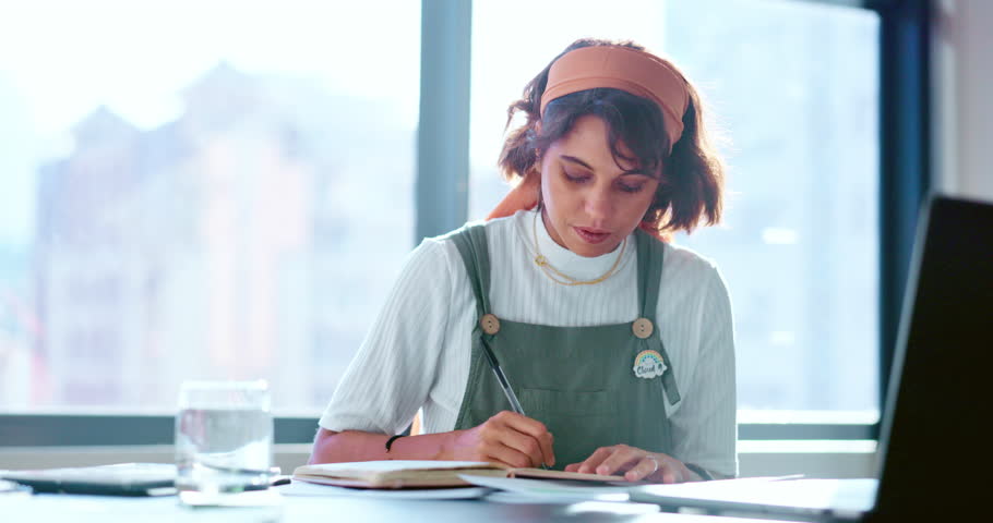 Laptop, planning or business woman writing in notebook for creative research, marketing SEO or advertising growth. Thinking, startup or employee in office for strategy review, search or blog content