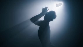 Silhouette of woman with shot hairstyle performing gorgeous dance moves by hands. Graceful fit female dancing in studio with smoke and spotlight. 4K slow motion art concept footage shot on RED camera - Powered by Shutterstock - Get 15% off with code: PIKWIZARD15