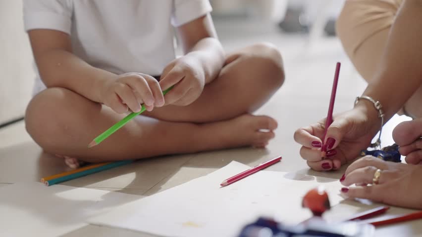 Loving millennial Latin foster mom relax on warm floor with small kid adopted daughter engaged in drawing create fairy tale in pictures. Mother and child girl coloring sketches in album using pencils
 Royalty-Free Stock Footage #1099685799