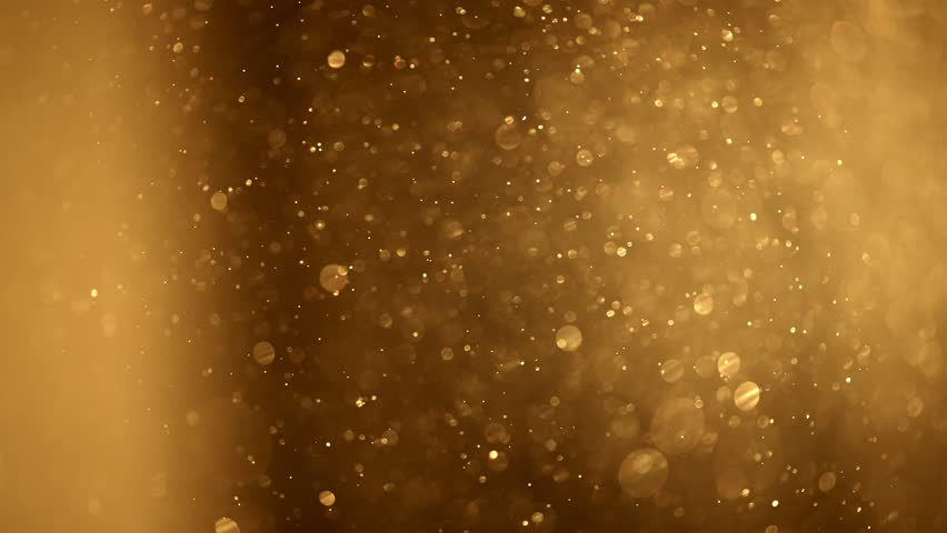 Shining golden particles abstract background. Gold dust particles fly in the air. Glimmering glowing gold bokeh background. Magical fairy background | Shutterstock HD Video #1099686455