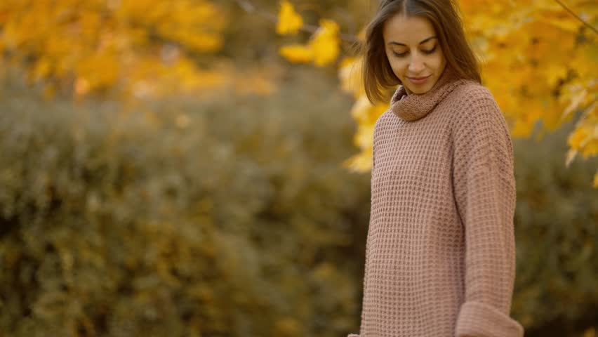 Stunning young brunette woman in autumn forest with yellow foliage. stylish attractive girl walks in park at warm fall day. slow motion 4k footage | Shutterstock HD Video #1099687573