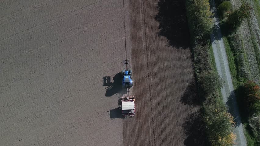 Tractor plowing autumn field in germany. Breathtaking aerial view flight drone | Shutterstock HD Video #1099687921