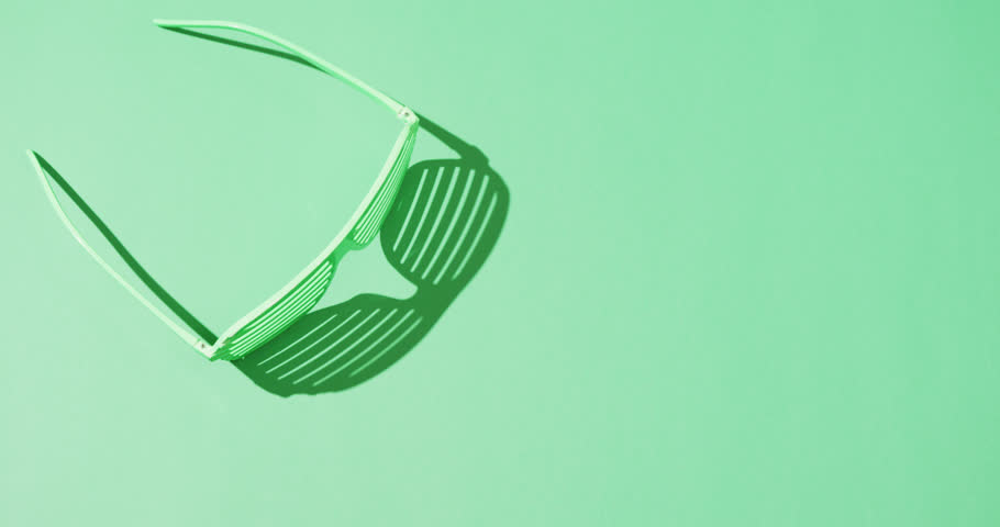 Video of st patrick's green glasses with copy space on green background. St patrick's day, irish tradition and celebration concept. | Shutterstock HD Video #1099689409