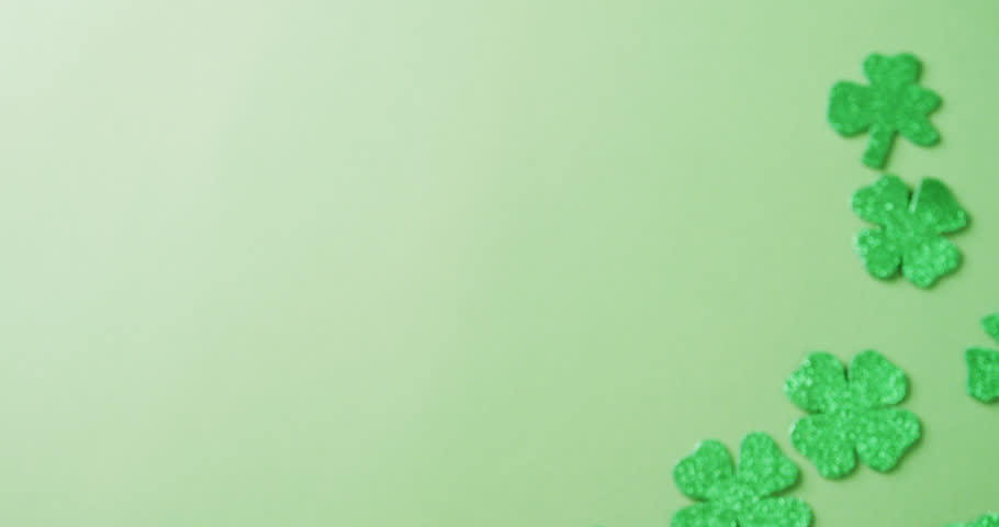 Video of st patrick's green shamrock leaves with copy space on green background. St patrick's day, irish tradition and celebration concept. | Shutterstock HD Video #1099689501