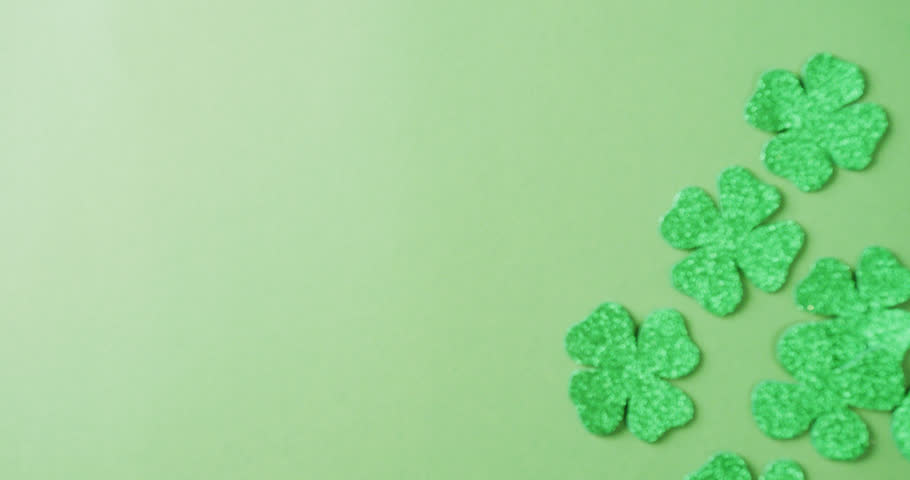 Video of st patrick's green shamrock leaves with copy space on green background. St patrick's day, irish tradition and celebration concept. | Shutterstock HD Video #1099689551