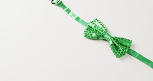 Video of st patrick's green bow tie with copy space on white background. St patrick's day, irish tradition and celebration concept.