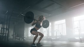Active, fit lady testing her strength with intensive workout. Close-up view of female powerlifter during a barbell training in dark, modern gym studio. High quality 4k footage - Powered by Shutterstock - Get 15% off with code: PIKWIZARD15