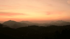 Scenic view of golden hour sunset on the foggy  mountains in Munnar, Kerala, India in winter - low light