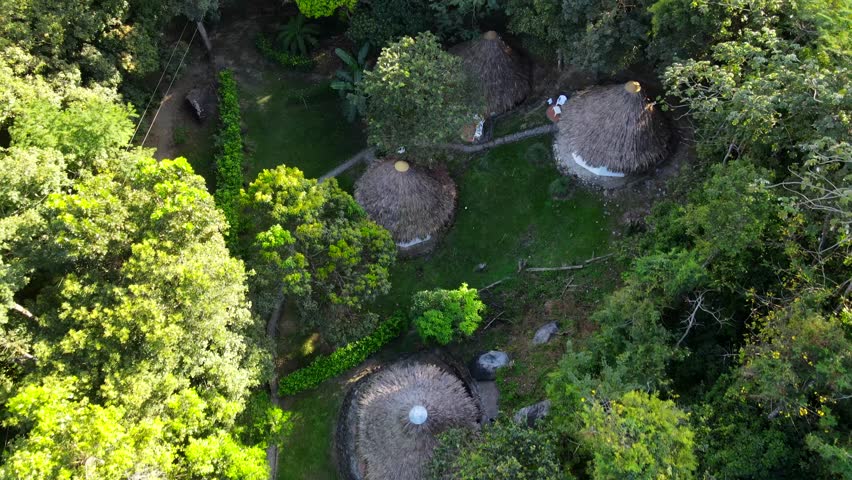 Aerial shot drone flies north over resort hidden in the forest in the mountains | Shutterstock HD Video #1099693385