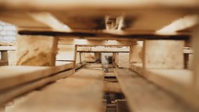 Wooden pallets are stacked next to the warehouse. The camera captures them in motion - Powered by Shutterstock - Get 15% off with code: PIKWIZARD15