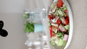 Meat salad. Caesar salad. cherry tomatoes. chicken salad with avocado, tomatoes, lettuce. Healthy chicken salad. vertical video