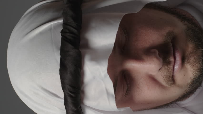 Man with united arab emirates traditional clothes posing in a studio. Beautiful islamic portrait of portrait arab businessman kandur. Studio footage with different poses