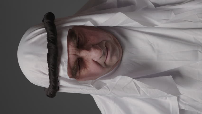 Man with united arab emirates traditional clothes posing in a studio. Beautiful islamic portrait of portrait arab businessman kandur. Studio footage with different poses