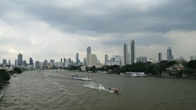 City view from Chao Phraya Sky Park. Tourist excursion boats travel on the Chao Phraya river. Bangkok, Thailand. 4k video 