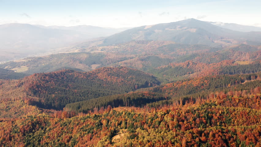 Aerial footage of mountainous scenes with minutes of greens, yellows, and reds. Pretty pine trees across breathtaking wild backcountry. High quality 4k footage