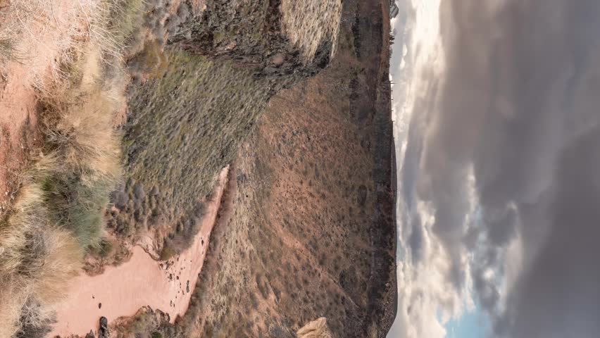 The Virgin River in southern Utah flowing through a gorge with a cloudscape overhead - vertical panoramic time lapse