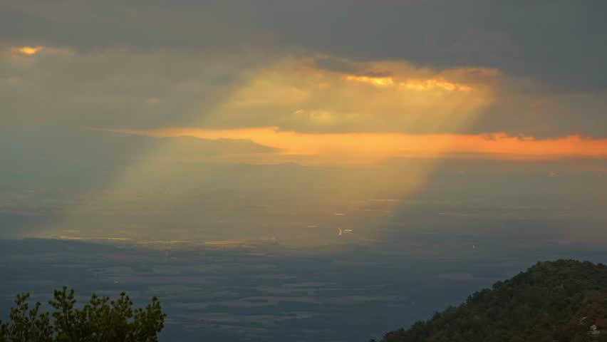 Light rays shining through clouds in Catalan mountain range, Spain | Shutterstock HD Video #1099735393